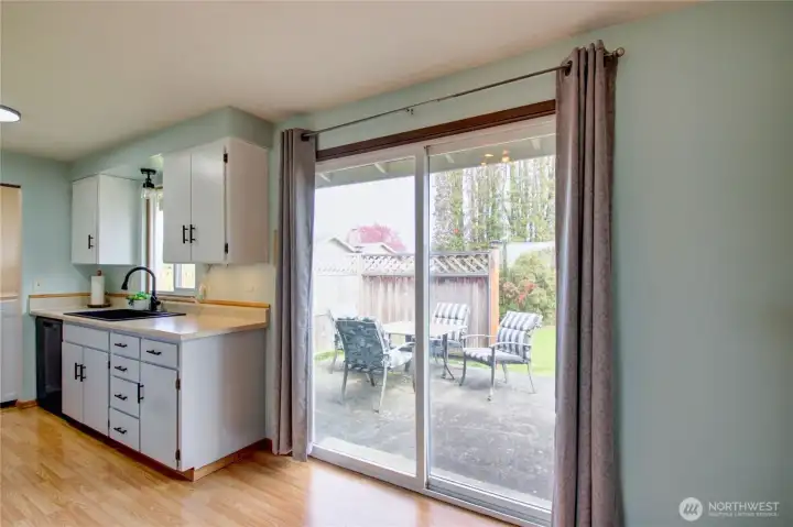 Dining room looking into the kitchen and outside patio.
