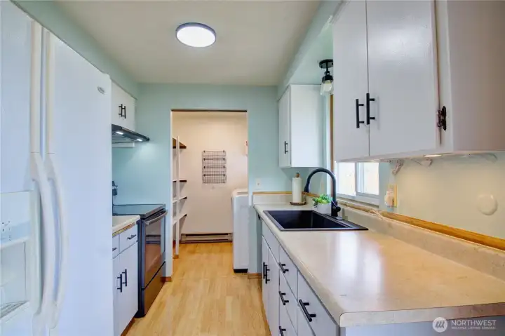 Kitchen with laundry and pantry at the end.