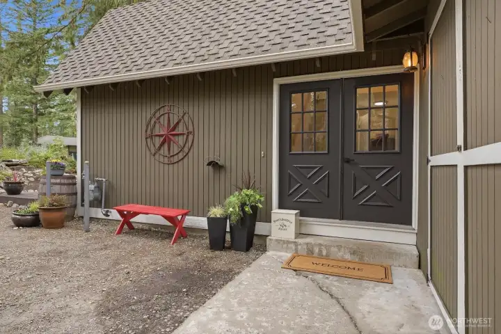 Welcoming double front doors open to a charming home with a cute front yard space.