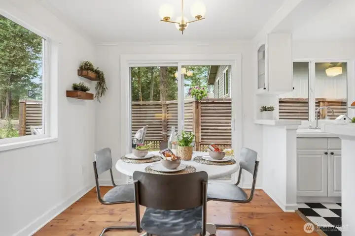 Dedicated dining area featuring a slider that opens to a spacious wraparound deck—ideal for indoor-outdoor living.