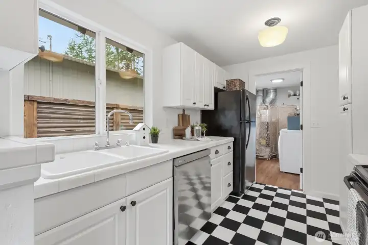 A large kitchen window fills the space with natural light while providing beautiful views of the outdoors.