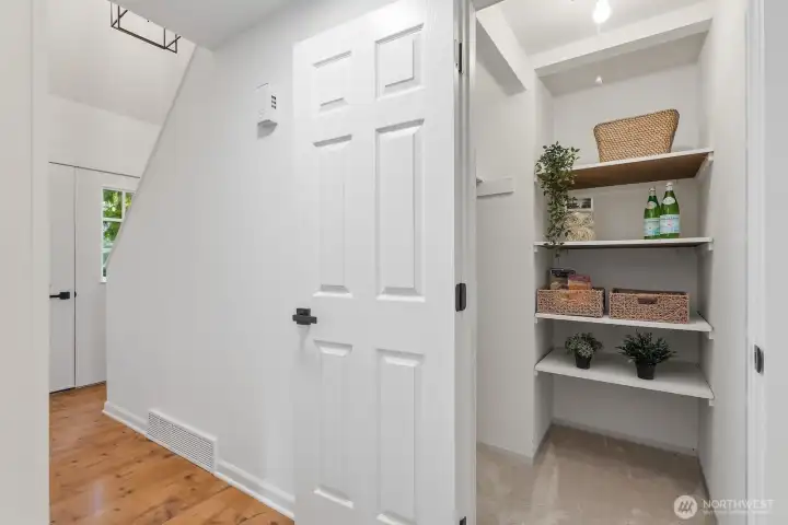 Generous walk-in pantry with ample storage space.