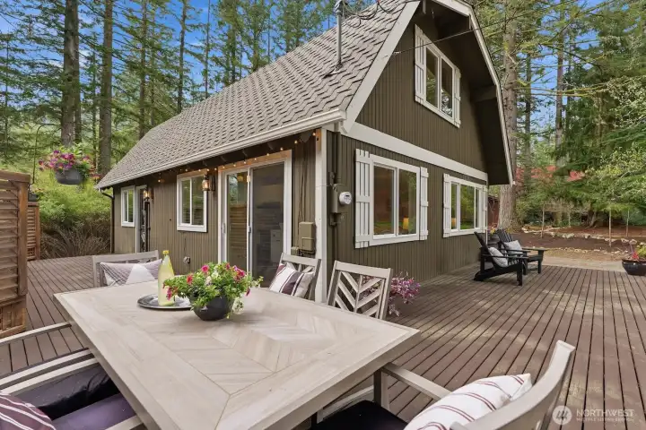 A spacious, freshly stained 300 sq ft wraparound deck with privacy fence extends your living space outdoors—perfect for gatherings or quiet moments.