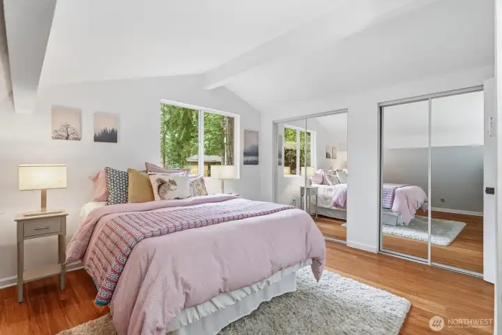 One of two upstairs bedrooms with double closets for ample storage and vaulted ceilings for spacious feel.