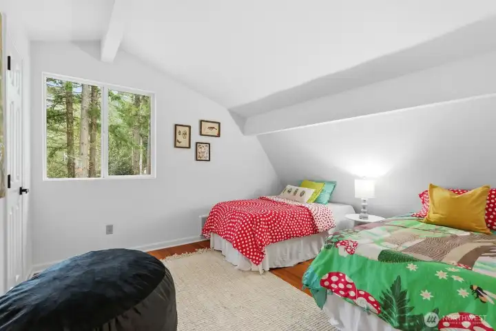 Spacious second upstairs bedroom offering vaulted ceilings and fresh paint throughout the upper floor.