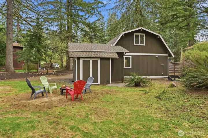 Private retreat with lush landscaping and a fire pit area, creating the perfect setting for relaxing evenings or entertaining.