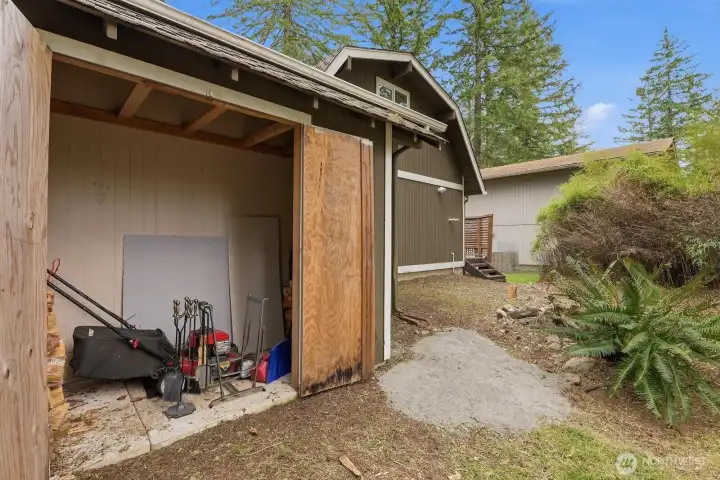 Convenient attached yard equipment storage area located at the rear of the garage.
