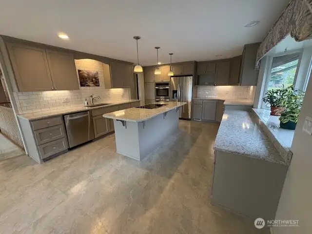 Beautifully updated kitchen - quartz countertops, easy close draws and pull outs