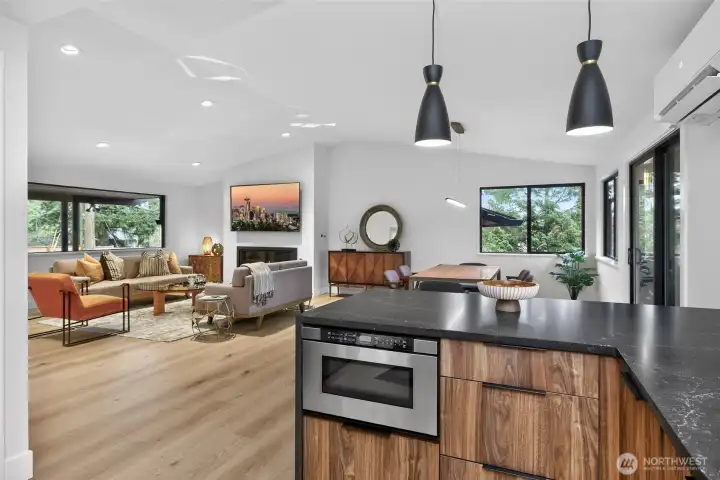 Honed countertops and waterfall edge at the breakfast bar kitchen island with microwave-drawer. Honed countertops and waterfall edge at the breakfast bar kitchen island with microwave-drawer.