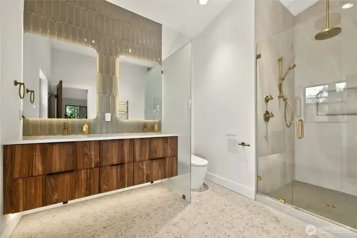 Stunning master bath features vaulted ceilings, heated terrazzo floors, double vanity with undercabinet lighting on dimmer, back-lit LED mirrors, custom tile feature walls, and a Smart Bidet Toilet with night-light and "the works"..... Stunning master bath features vaulted ceilings, heated terrazzo floors, double vanity with undercabinet lighting on dimmer, back-lit LED mirrors, custom tile feature walls, and a Smart Bidet Toilet with night-light and "the works".....