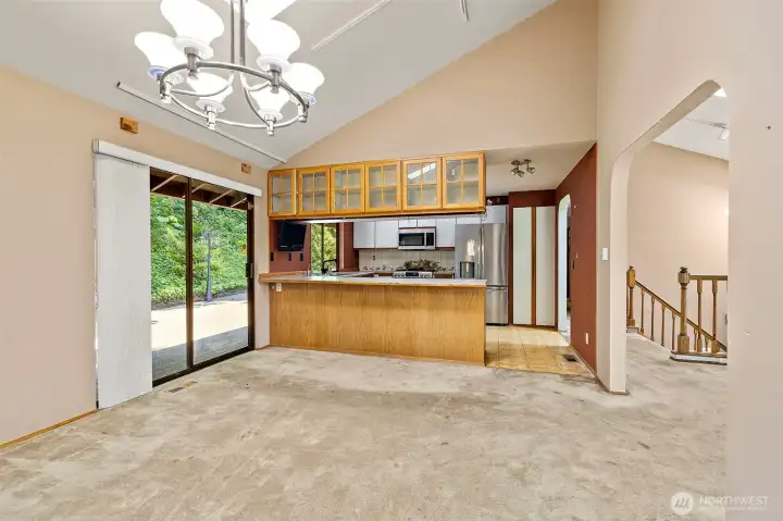 Dining room opens into kitchen and living room.  Large skylights add natural light to the room.