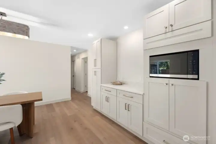 Built-in coffee bar with custom cabinetry and counter space adds everyday convenience and elevated kitchen function.