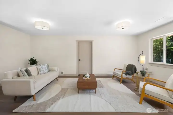 Spacious family room with natural light, updated flooring, modern lighting, and plenty of room for everyday living or movie nights.