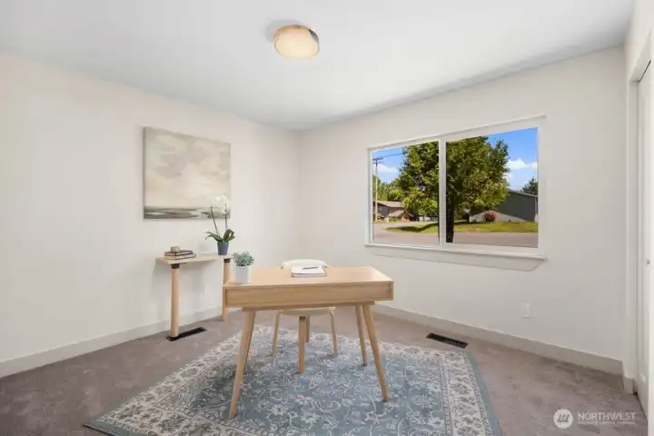 Flexible fourth bedroom or home office with large window, new carpet, updated lighting, and great work-from-home potential.