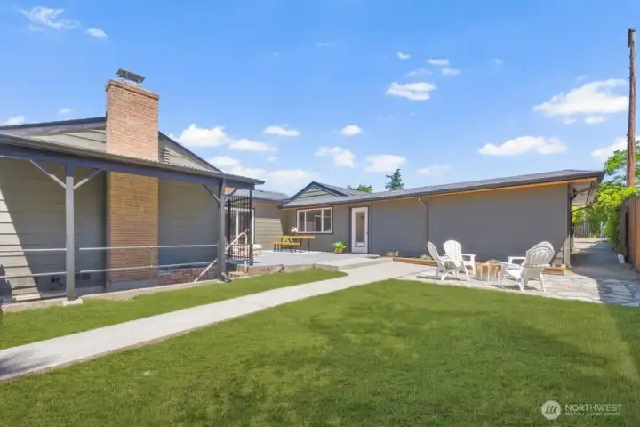 Fully fenced backyard with lawn, patio space, and multiple areas for outdoor entertaining or pets.