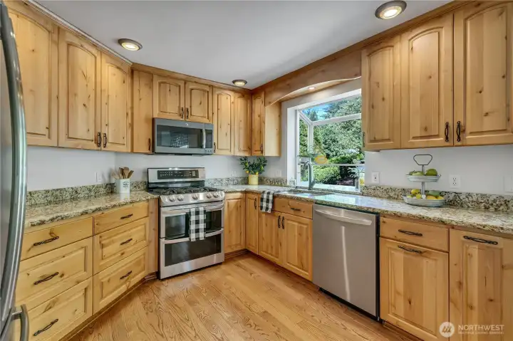 Enjoy a complete kitchen remodel! Custom Rustic Alder cabinetry, granite counters & newer appliances await!