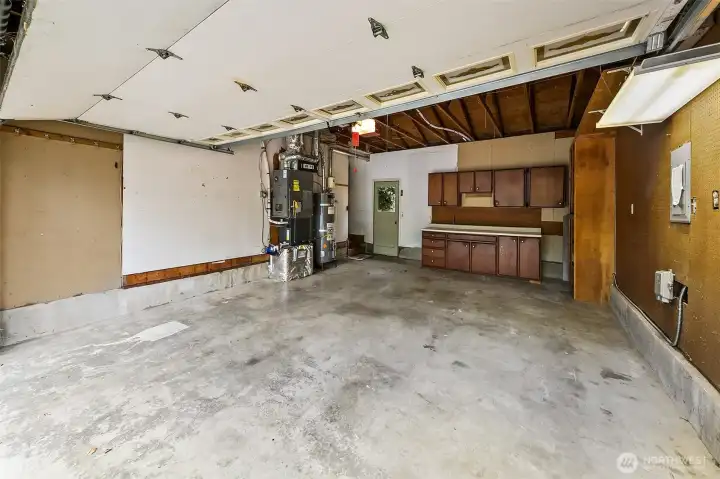 Garage with workbench and door to backyard