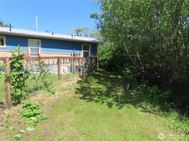 Back of home and property partly fenced