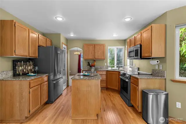 Open kitchen with eat in area with access to family room and deck.