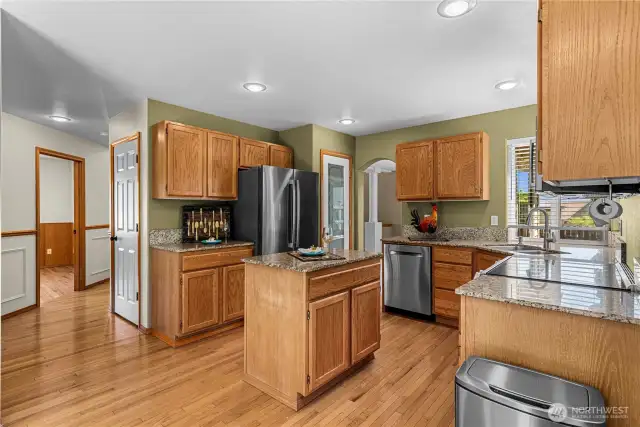 Open kitchen with eat in area with access to family room and deck.