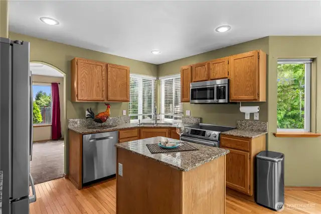 Open kitchen with eat in area with access to family room and deck.