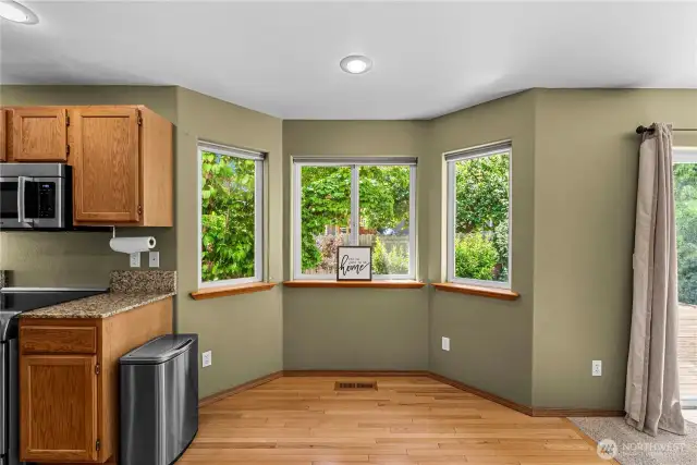 Open kitchen with eat in area with access to family room and deck.