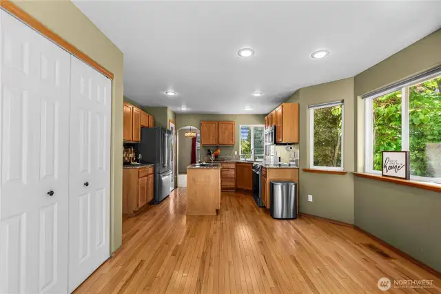 Open kitchen with eat in area with access to family room and deck.