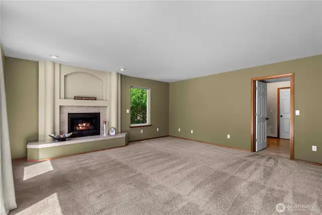 Family room with fireplace and access to  deck and private back yard.