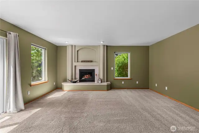 Family room with fireplace and access to  deck and private back yard.