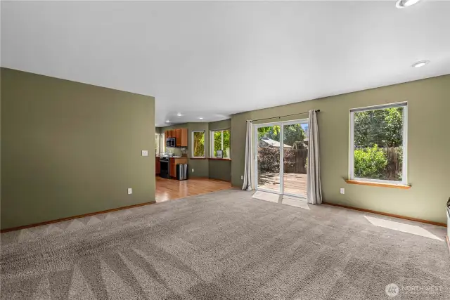 Family room with fireplace and access to  deck and private back yard.
