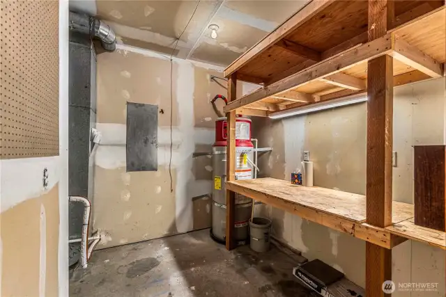 Separate room in garage for furnace and water heater.