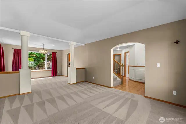 Open concept living and dining room with decorative tray ceilings.