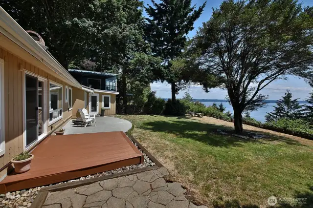 Patios and decks provide plenty of space to entertain. Lots of yard space too! This part of the yard is fenced.