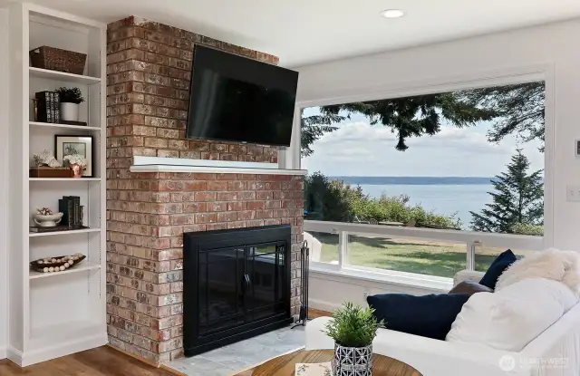Built in shelving on both sides of the fireplace. The hallway to the three bedrooms is to the left of the bookshelf.