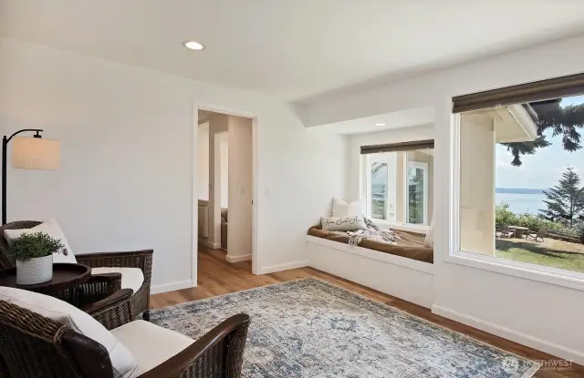 You have just stepped into the Primary Suite which extends through the doorway ahead. The bathroom is located just beyond the right edge of this photo.
