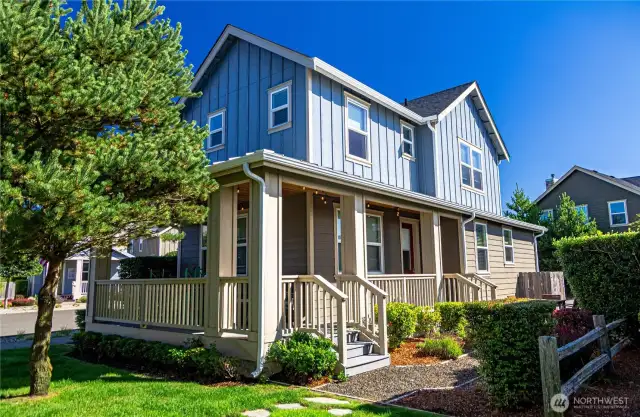 Front of house adjacent to beautiful green space and featuring a covered porch