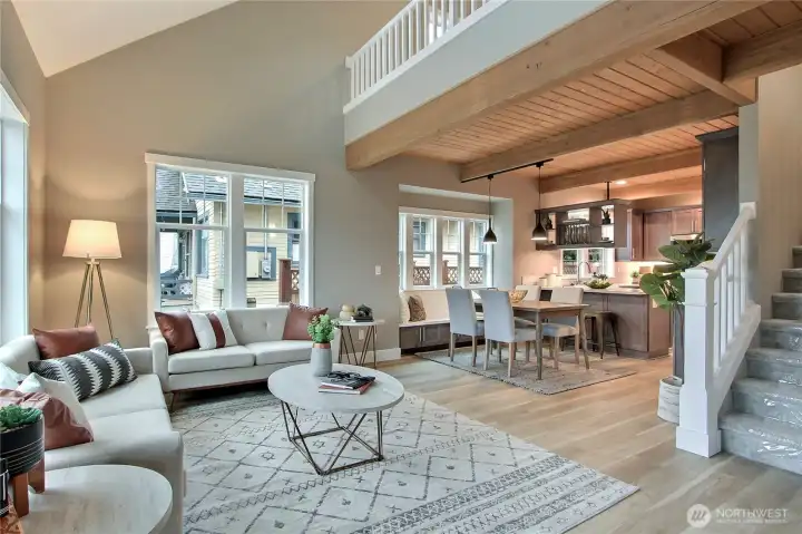 Great Room with custom craftsman details throughout including open railings, authentic craftsman millwork & built-in bench. The vaulted ceilings accentuate the open floor plan, which is an award-winning floor plan designed for luxury & efficiency.