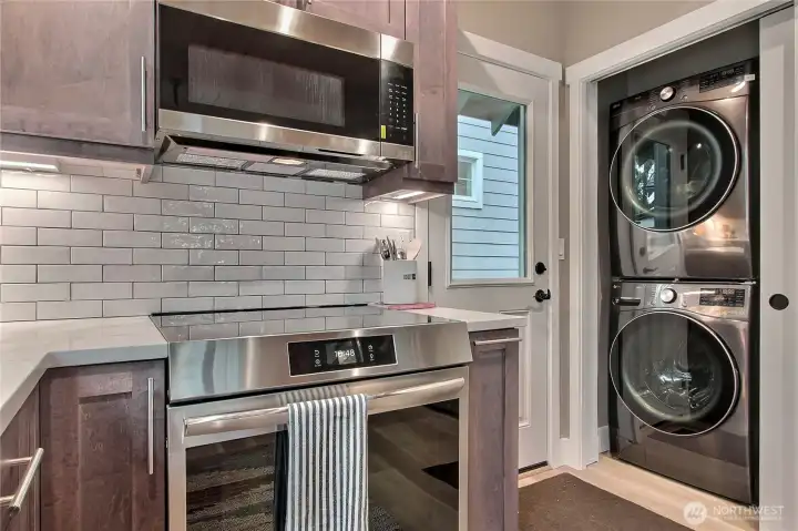 Electric induction stove with air fryer. Full-sized washer & dryer conveniently located next to the pantry/storage closet.