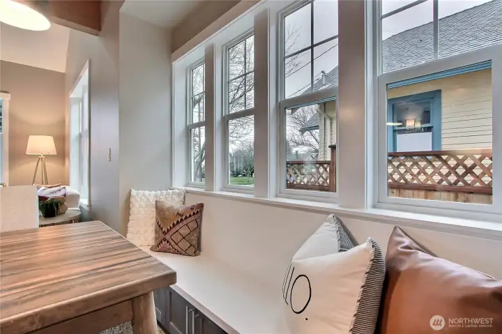 Custom-designed seating bench with storage shelves underneath.