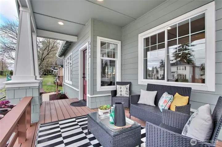 Front covered porch with seating bench and planters. A truly custom craftsman architectural detail.