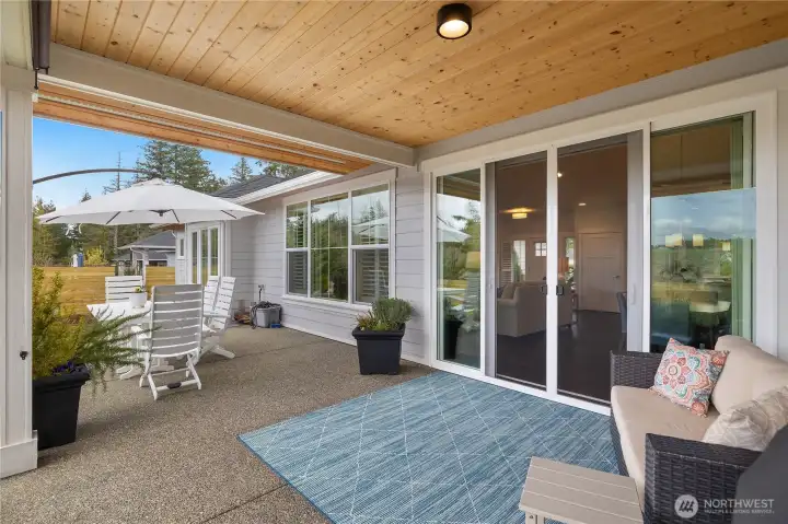 The spacious & covered BBQ patio features sun screens & an adjacent open area.