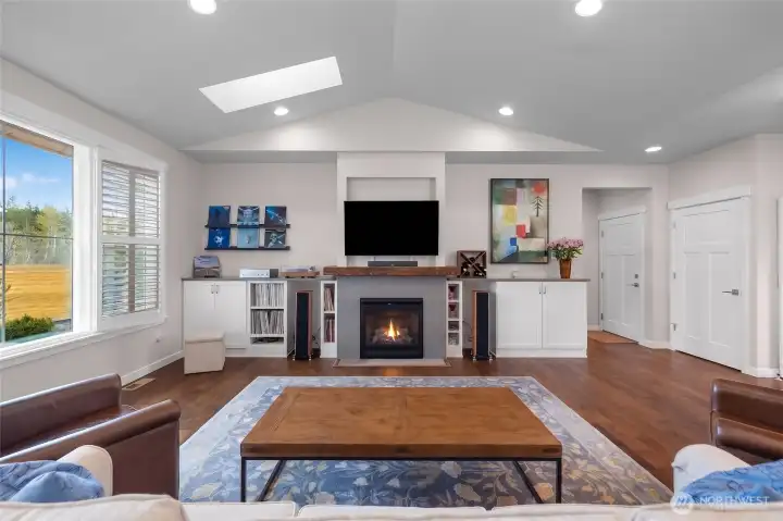 The media wall includes lower built-ins and a gas fireplace