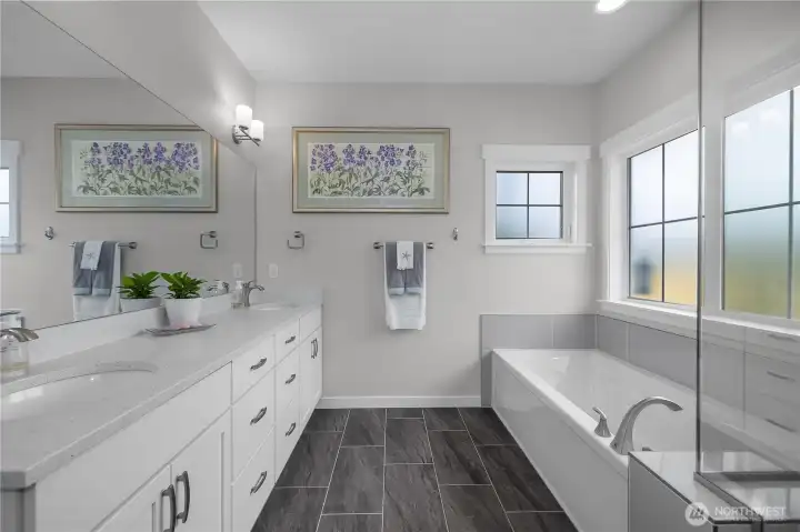 His and hers vanities with ample storage.