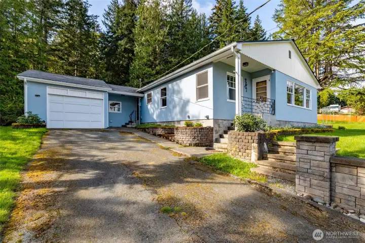 Gently sloped driveway to the oversized one car garage.