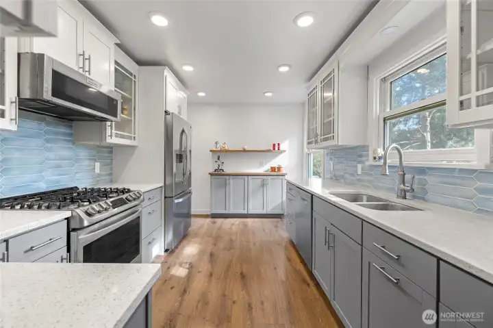 WOW!! Quartz counter tops, stainless appliances, 5 burner gas stove top, easy close shaker cabinets and pullout drawers. Trash and recycle cabinet, lazy susan, and cookie sheet cabinet too. LVP flooring throughout the home.