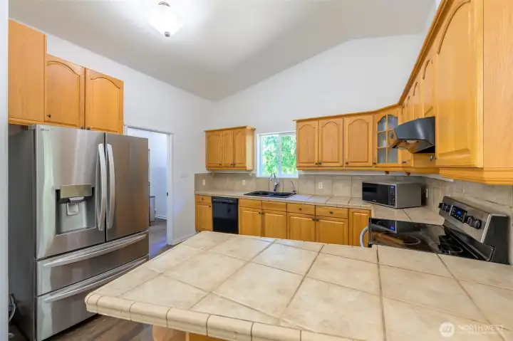 The kitchen has a back door entrance to laundry room/pantry. The kitchen has a back door entrance to laundry room/pantry.