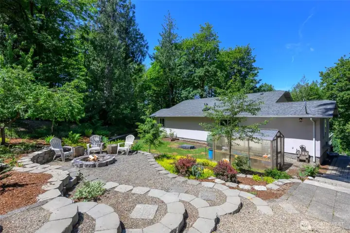 Terraced fire pit area. Green house on the back of the house. Terraced fire pit area. Green house on the back of the house.
