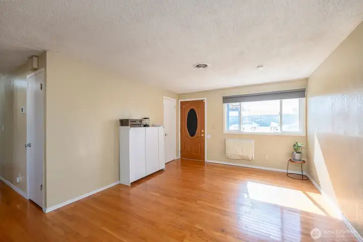 Step into the living room and enjoy the open feeling of the home. Gorgeous original wood flooring.