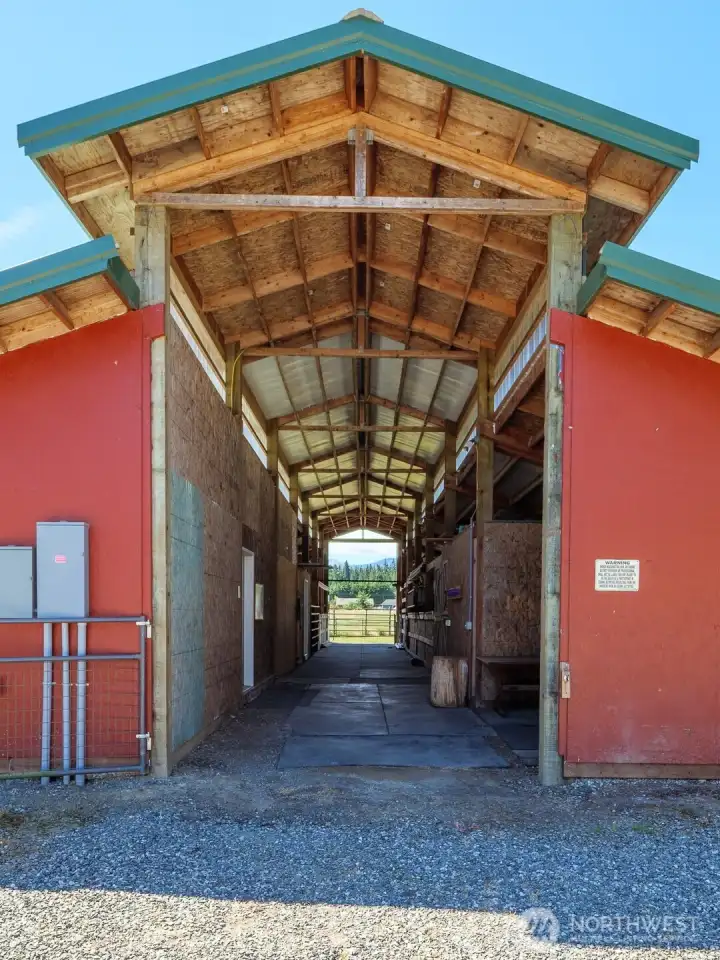 36 X 82 horse barn with 8 stalls, fenced paddocks, climate controlled workshop and tack rooms, stall mats