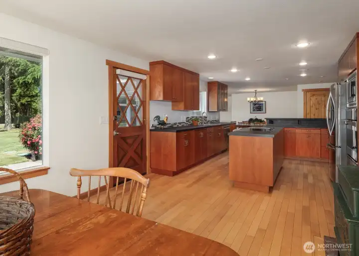 Kitchen with eating space includes wood stove and door to west facing deck